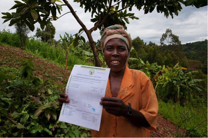 Liberata holds the title deed for the land she owns in Rwanda. Photo: Landesa.